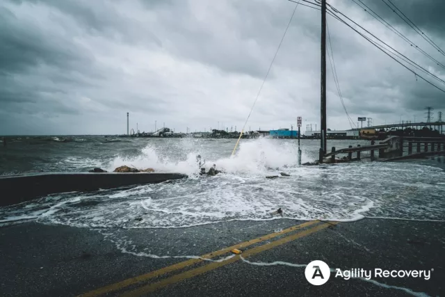 Storm surge from a hurricane washing over a road