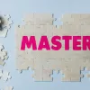 The word mastery being formed with puzzle pieces stating knowledge and wisdom